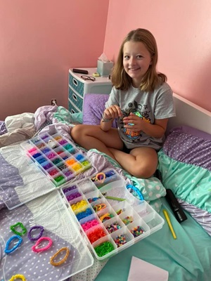 Ava working on her bracelets